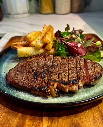 Ribeye Steak, Peppercorn Sauce, Rosemary Fries & Parmesan Salad.