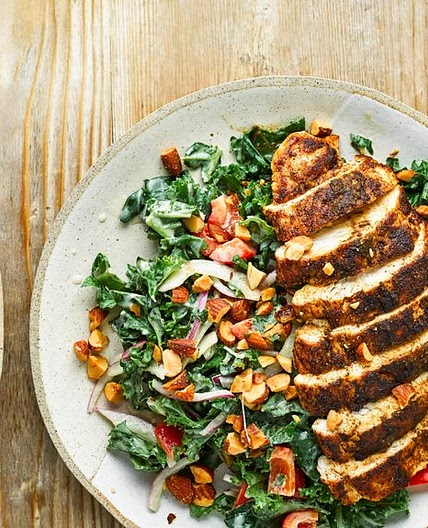 Cumin-crusted chicken with kale salad and hummus dressing