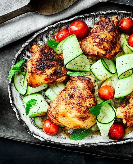 Paprika chicken thighs with cherry tomatoes, courgette ribbons and mint