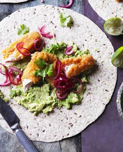Smashed avocado with crispy chicken, pickled onions & tortillas