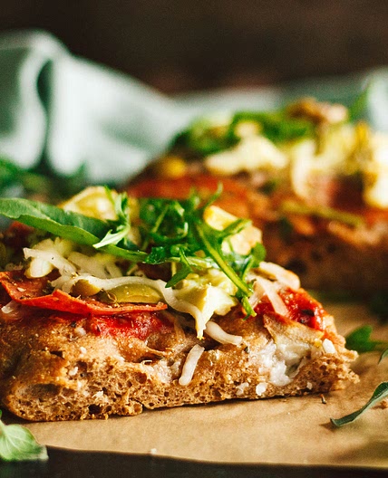 Salami, Artichoke, and Green Olive Pizza with Arugula on Focaccia