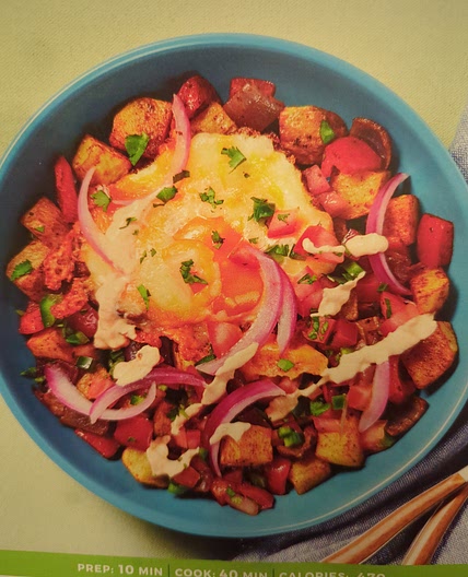 Cheesy fried eggs over nacho potato hash