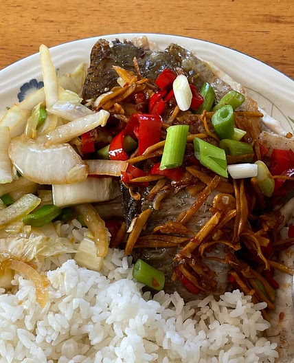 Sea bass with sizzled ginger, chilli & spring onions