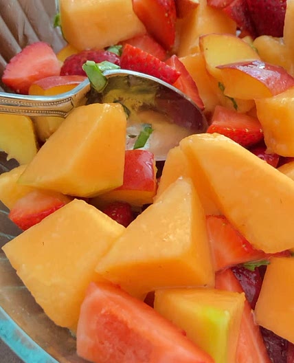 Summer fruit salad with basil lime dressing