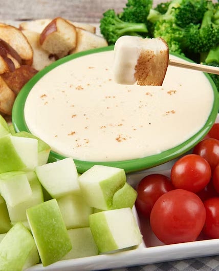 Swiss Fondue With Pretzel Bread, Broccoli, Tomatoes, and Apples