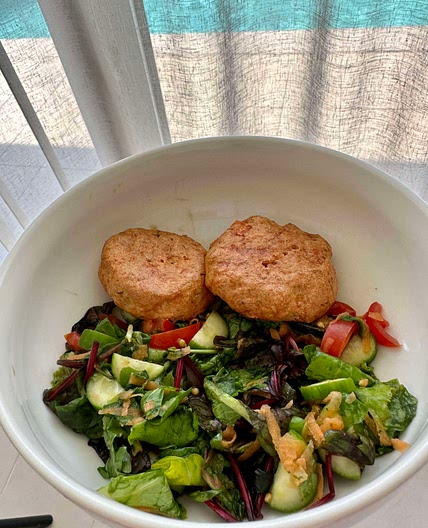 Salmon cakes on mixed greens 