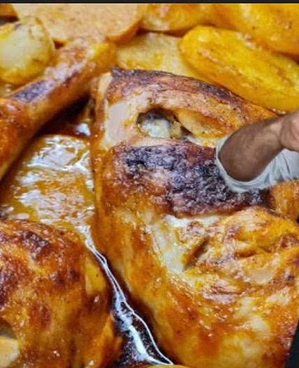 Tray of chicken with potatoes in the oven