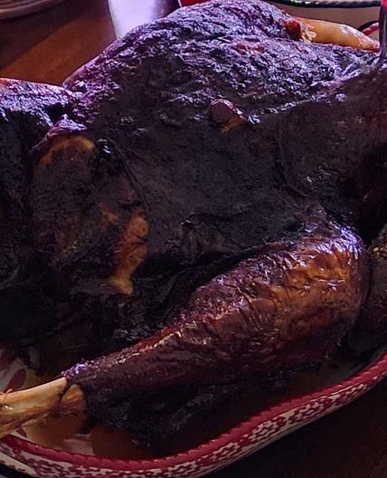 Smoked turkey in woodfire grill.
