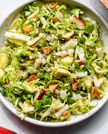 SHAVED BRUSSELS AND PEAR SALAD WITH MANCHEGO