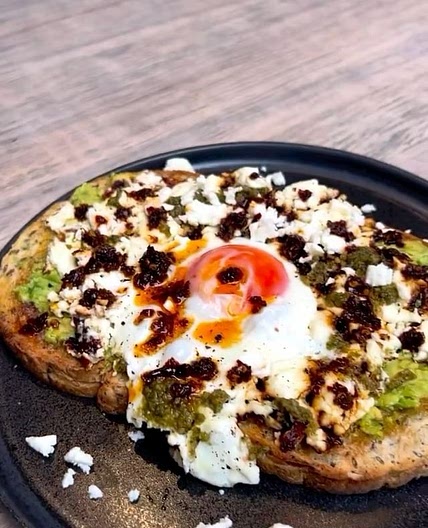 Crispy feta eggs with avocado, pesto & chilli oil