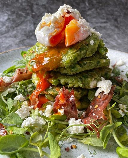 Pea fritters with a poached egg, feta, pea shoots and crispy prosciutto