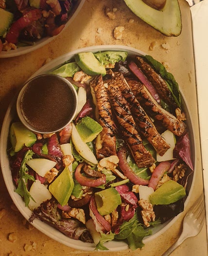 Vegan Walnut, avo and pear salad with marinated Portobello caps and red onion