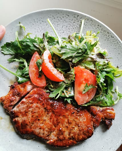 Porterhouse steak with salad in sesame dressing