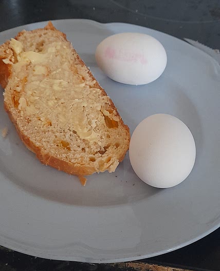2 sot boiled eggs and 1 piece of bread and butter