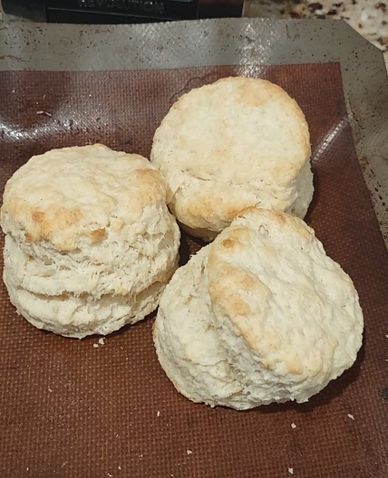 Biscuits and gravy with eggs and hash browns