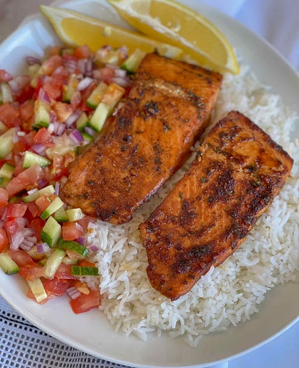 Salmon served with rice and a simple salad 