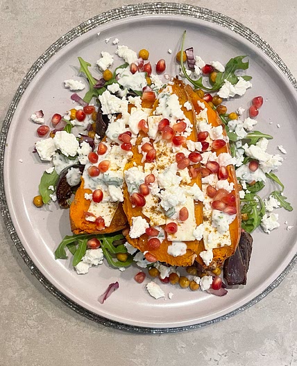 Delicious slow-roasted sweet potato with feta and pomegranate