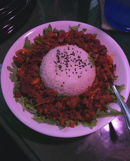 Gochujang stir fry with steamed rice over arugula