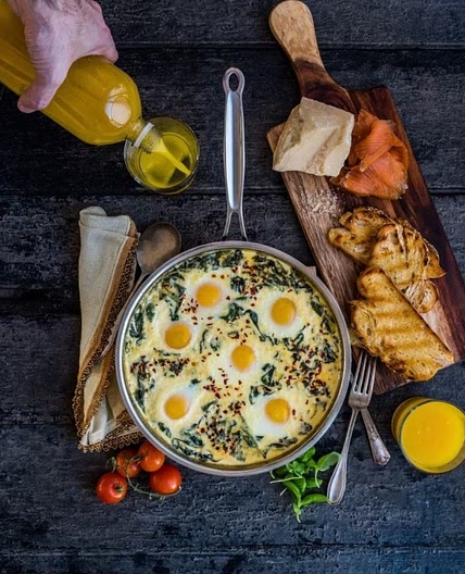 Baked Eggs in Ricotta Parmesan Creamed Spinach