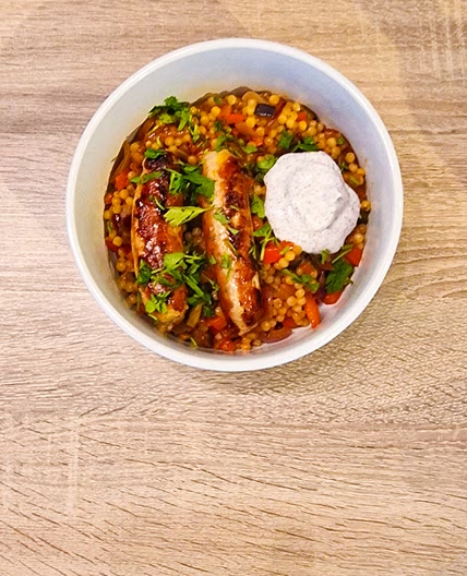 Saucisses de poulet sur couscous perlé lebné, aubergine et sumac