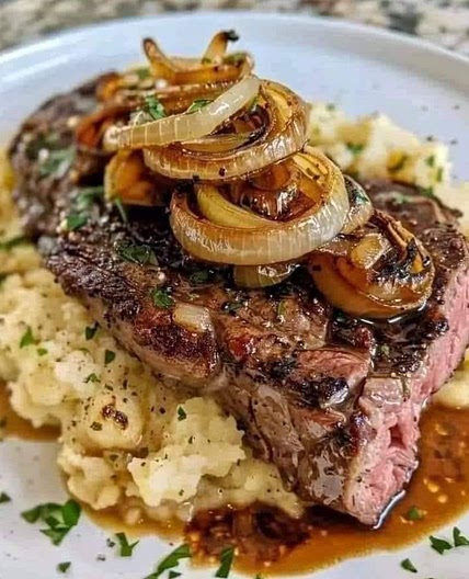 Ribeye steak with caramelised onions and mashed potatoes