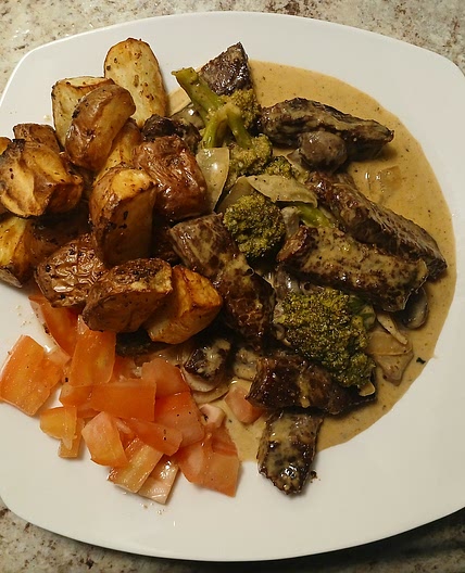 Roasted potatoes with steak, veggies, and buttery cream