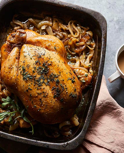 Roast chicken with tarragon butter and melting onions