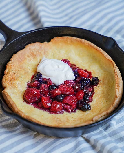 Individual Dutch baby pancake with berries and maple yogurt