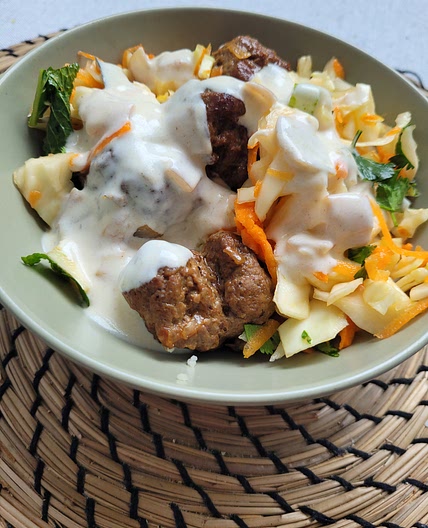 Lamb meatballs with cous cous and cabbage salad