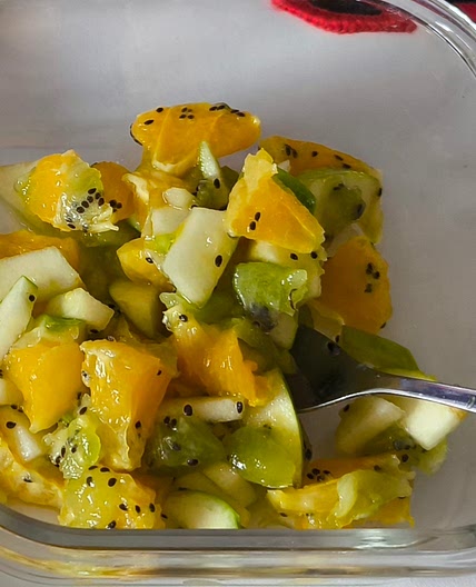 Fruit salad with kiwi, orange, and apples
