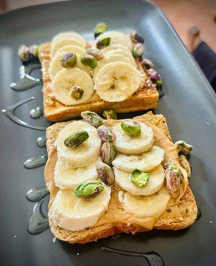 Toasted Whole Grain Bread with Cashew Butter, Air-Fried Banana, Agave Syrup & Pistachios