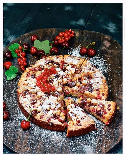 Quick almond paste cake with red berries and hazelnuts