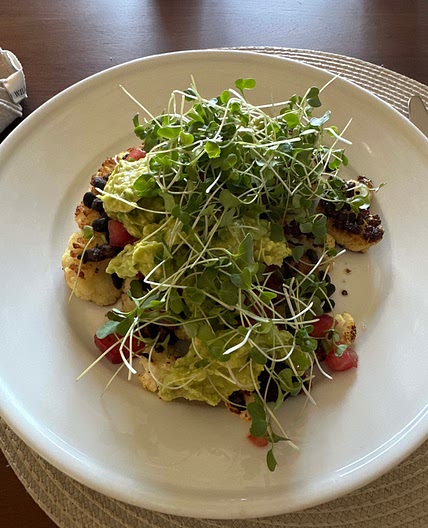 Cauliflower steak with black beans and diced tomatoes
