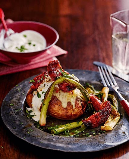 Crisp-skinned jackets with cheese, chorizo and spring onions