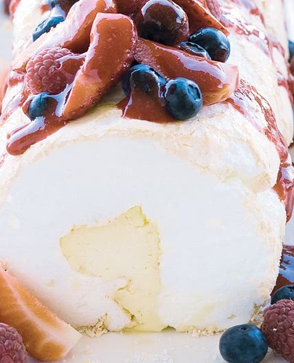 Soft pavlova roll with liqueur mascarpone and berry compote