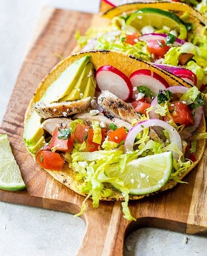 Grilled Chicken Tacos with Lettuce Slaw, Avocado and Cotija