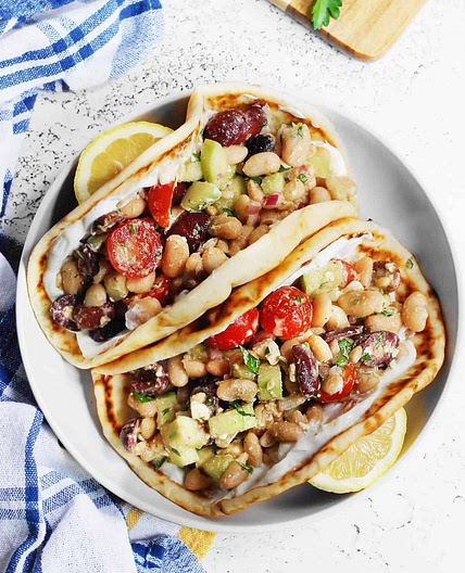Greek salad wraps with white beans and garlic yogurt
