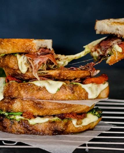 Loaded caprese toasties with pesto, onion jam and serrano ham