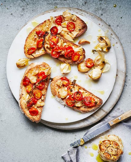 Confit garlic with roasted tomatoes on toast