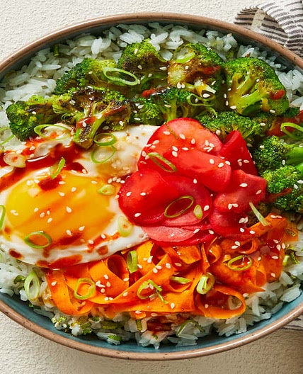 Broccoli-Carrot Donburi with a Fried Egg over Scallion Lime Rice with Pickled Radishes & Sesame Seeds
