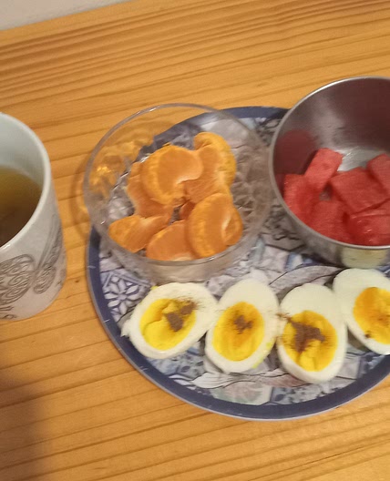 Boiled eggs with orange and watermelon