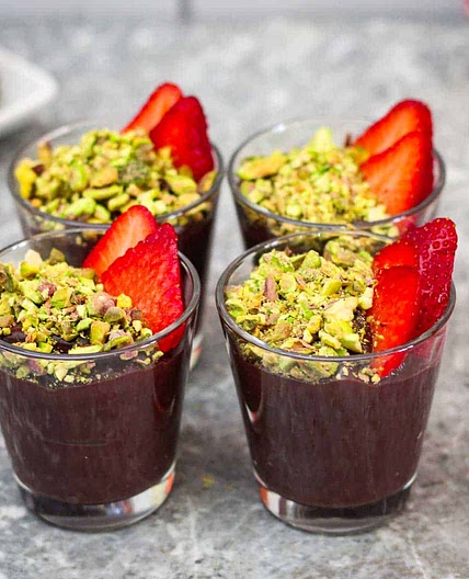 Chocolate Pudding topped with Pistachios and Strawberries