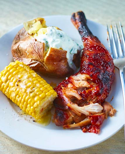 Pulled chicken with barbecue sauce and baked potatoes