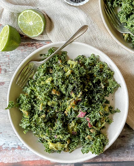 Kale Salad with tahini and herb dressing, dates, pistachios and poached chicken