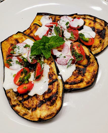 Grilled eggplant with tomatoes and yogurt sauce