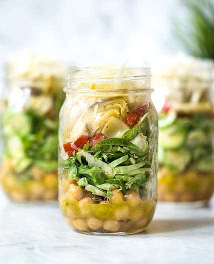 Raw Brussels Sprouts and Chickpea Salad in a Jar with Artichokes, Sun Dried Tomatoes and Asiago