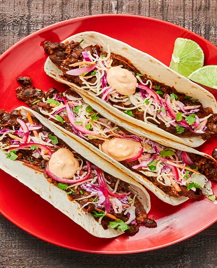 Smashed Black Bean Tacos with Creamy Slaw, Pickled Onion & Red Pepper Crema