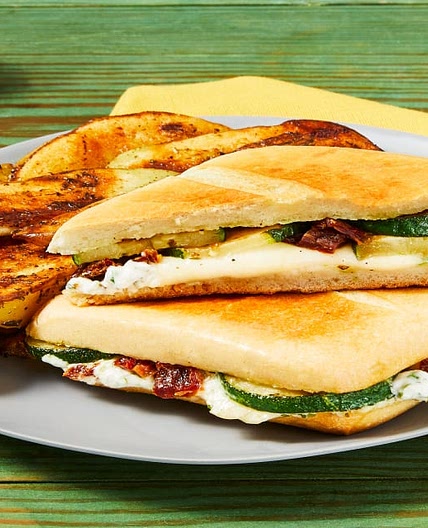 Zucchini, Mozz & Sun-Dried Tomato Panini with Herb Sauce & Italian-Seasoned Potato Wedges