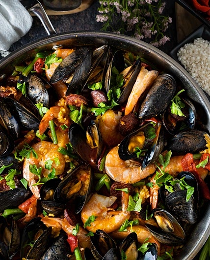 Paella with chicken, chorizo and seafood