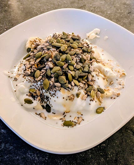 Fruit, oats yogurt & seeds breakfast bowl